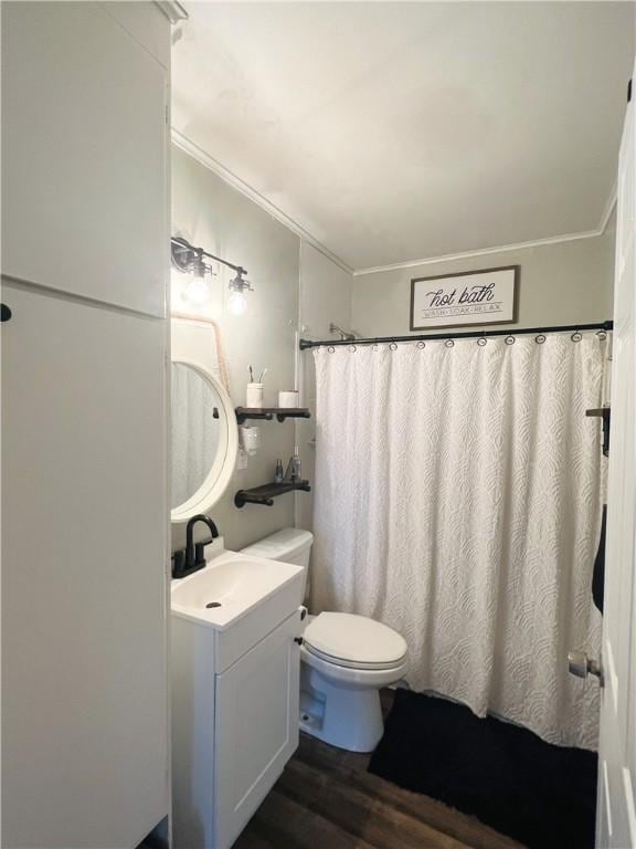 bathroom with hardwood / wood-style flooring, vanity, toilet, and ornamental molding