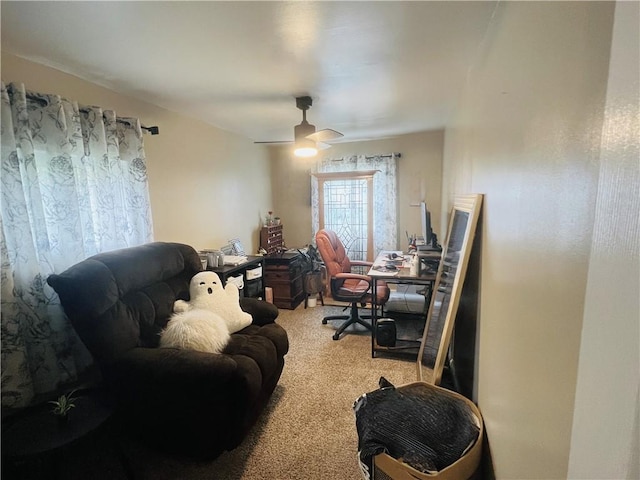 carpeted office space with ceiling fan