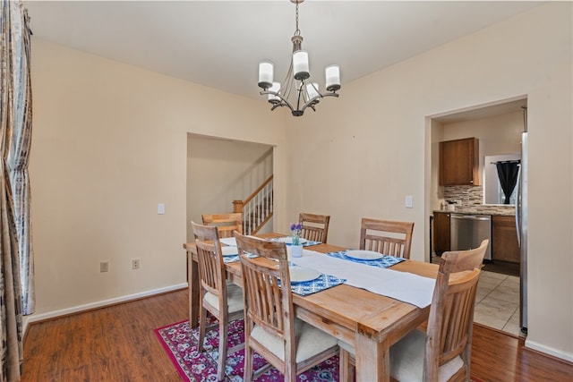 dining area with a notable chandelier and dark hardwood / wood-style floors