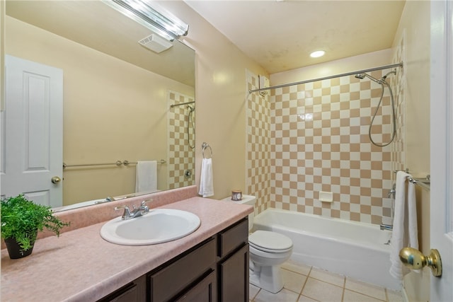 full bathroom featuring tile patterned flooring, tiled shower / bath combo, vanity, and toilet