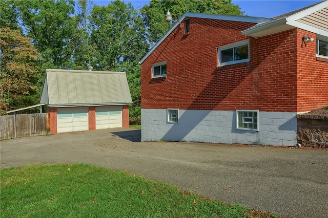 view of home's exterior with an outbuilding and a garage