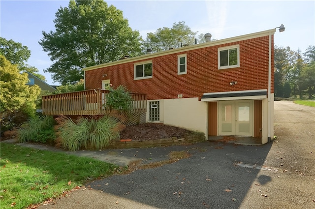 back of property featuring a deck