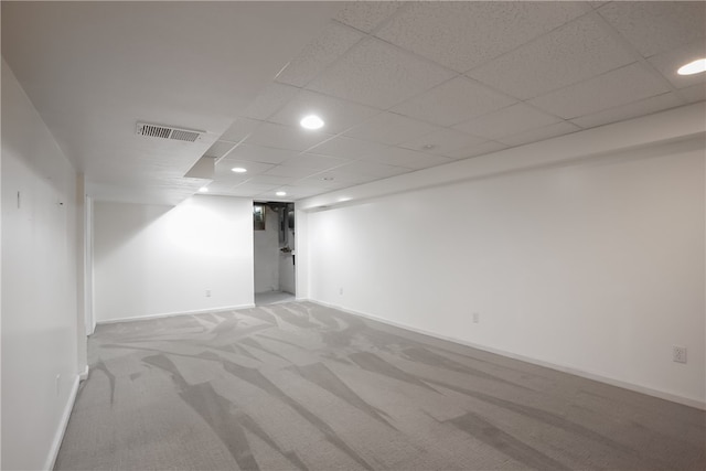 unfurnished room with a paneled ceiling and carpet