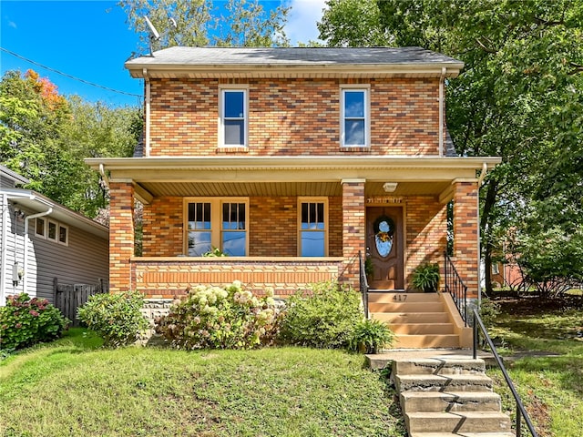 view of front of house with a front yard and a porch