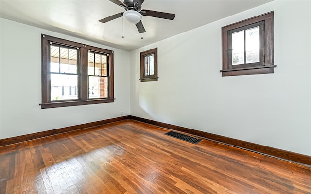 spare room featuring ceiling fan, plenty of natural light, and hardwood / wood-style floors