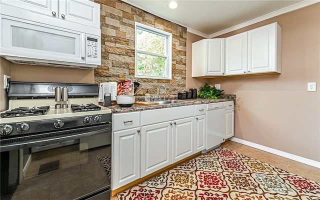 kitchen with sink, white cabinets, white appliances, light tile patterned floors, and ornamental molding