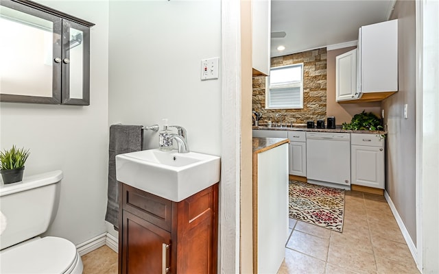 bathroom featuring ornamental molding, tile patterned floors, vanity, and toilet