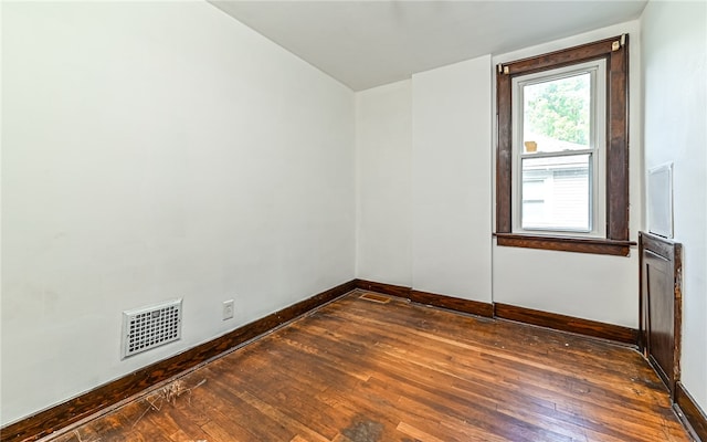 unfurnished room with dark hardwood / wood-style floors