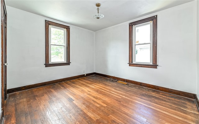 unfurnished room featuring dark wood-type flooring