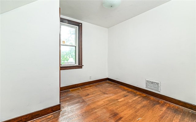 spare room featuring dark hardwood / wood-style flooring