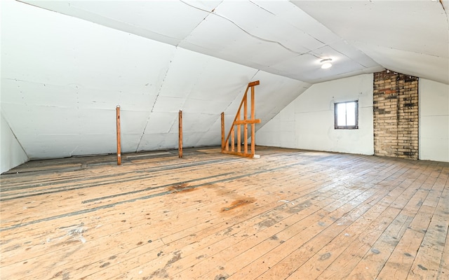 bonus room featuring vaulted ceiling and hardwood / wood-style flooring