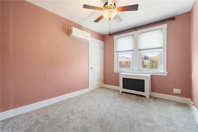 carpeted empty room featuring ceiling fan, radiator, and a wall unit AC