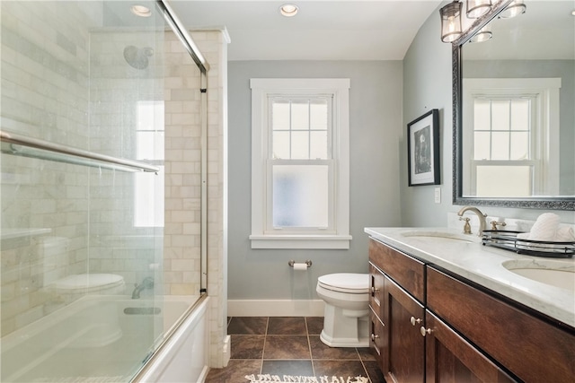 full bathroom featuring combined bath / shower with glass door, vanity, toilet, and tile patterned flooring