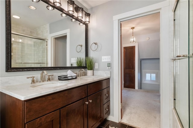 bathroom featuring vanity and an enclosed shower