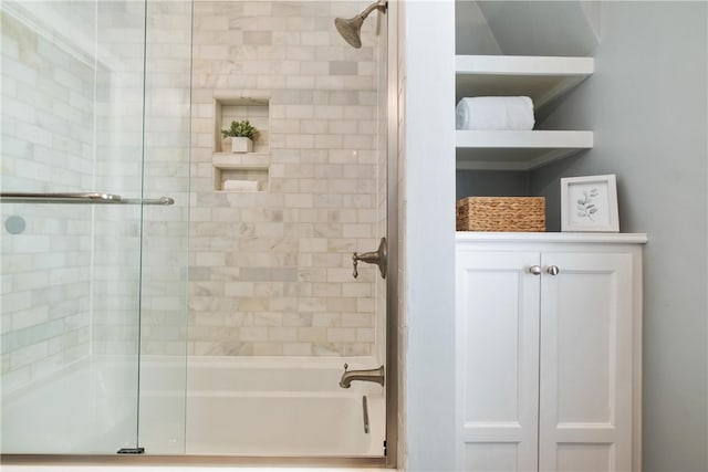 bathroom with shower / bath combination with glass door