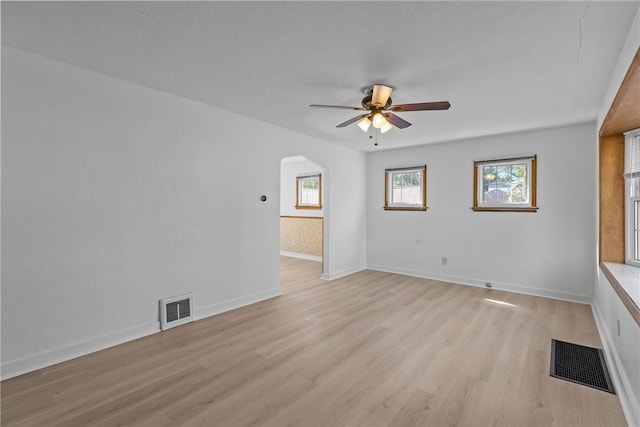 spare room with ceiling fan and light wood-type flooring