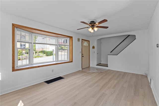 unfurnished living room with light hardwood / wood-style floors and ceiling fan