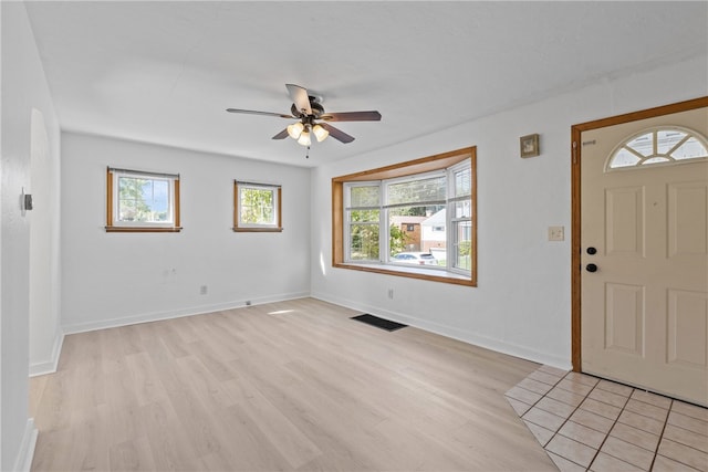 foyer entrance featuring light hardwood / wood-style flooring, a wealth of natural light, and ceiling fan