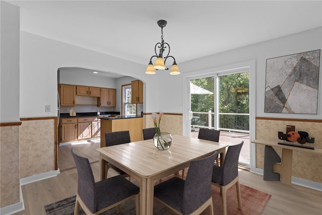 dining room with a notable chandelier and light hardwood / wood-style floors