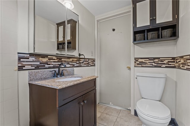 bathroom with vanity, toilet, tasteful backsplash, and tile patterned floors