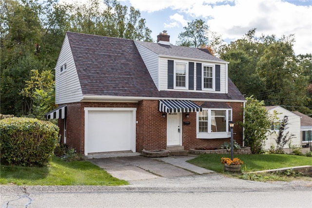 view of front of property featuring a garage and a front lawn