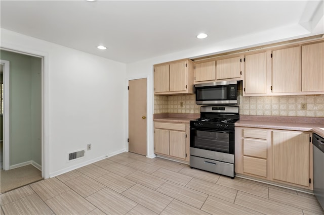 kitchen featuring backsplash, stainless steel appliances, and light brown cabinetry