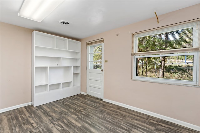 empty room featuring dark wood-type flooring