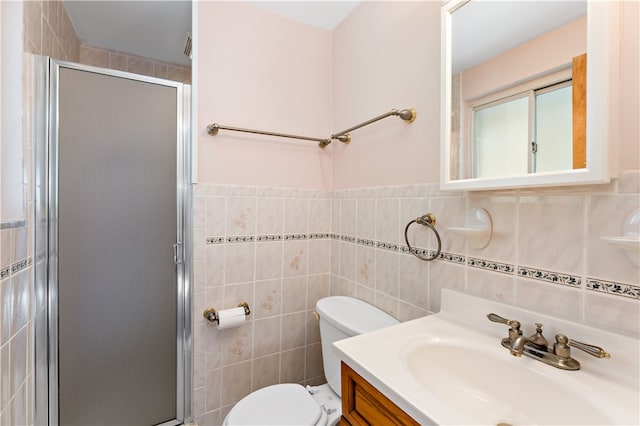 bathroom featuring vanity, tile walls, toilet, and an enclosed shower