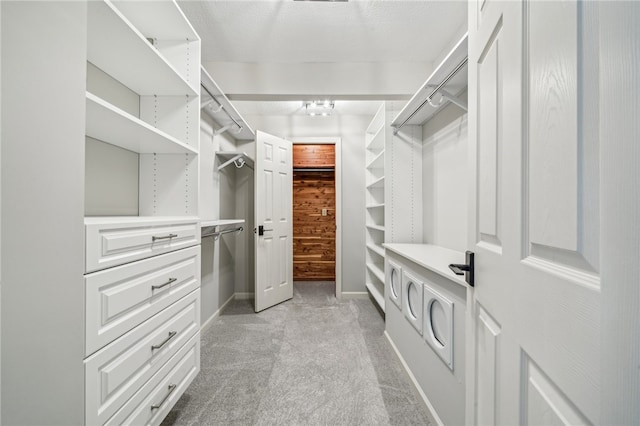 spacious closet featuring light carpet