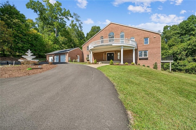 view of front of house with a front yard and a garage