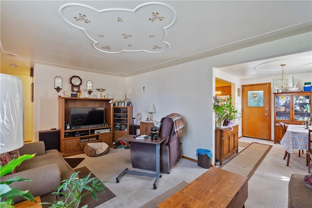 living room featuring light carpet and a notable chandelier