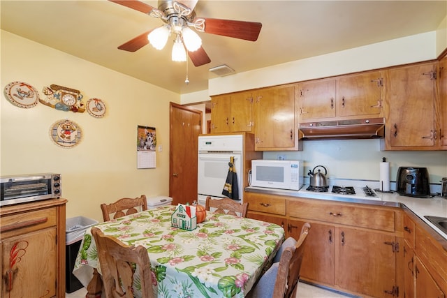 kitchen with white appliances and ceiling fan