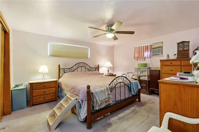 bedroom featuring ceiling fan, light colored carpet, a closet, and a wall mounted AC