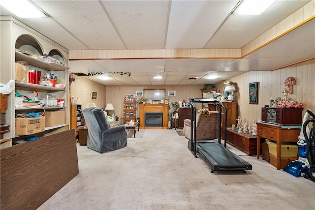 workout room with carpet floors and wood walls