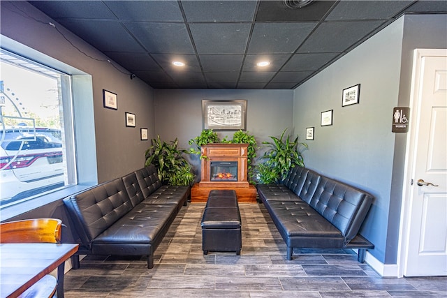 interior space featuring a drop ceiling and dark hardwood / wood-style flooring