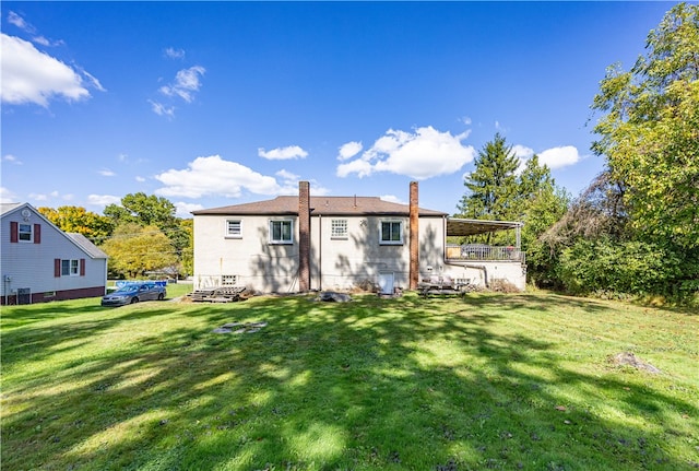 rear view of property with a lawn