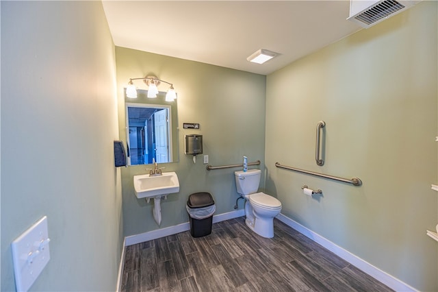 bathroom with hardwood / wood-style flooring, sink, and toilet