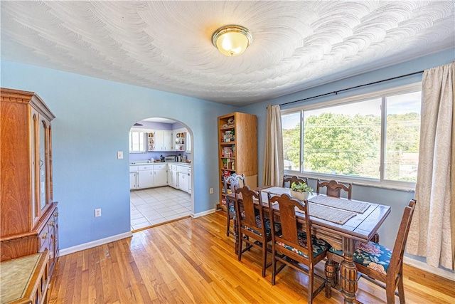 3740 Milligantown Rd, Upper Burrell, PA 15068 - dining room featuring arched walkways and light wood-style flooring