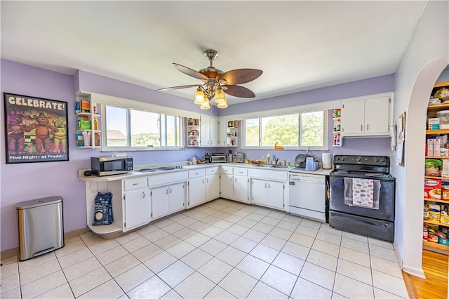 kitchen with plenty of natural light, white appliances, ceiling fan, and white cabinetry