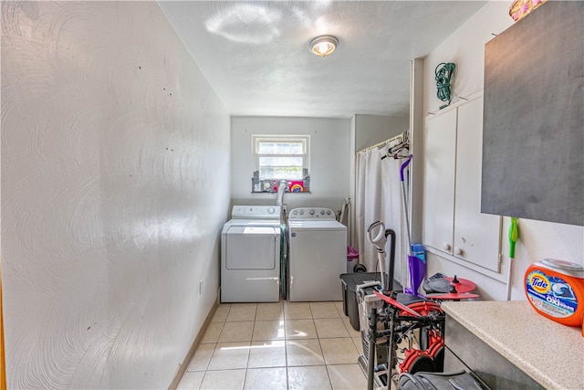 clothes washing area featuring light tile patterned flooring and independent washer and dryer