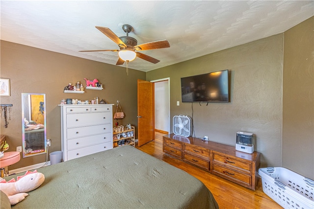 bedroom with light wood-type flooring and ceiling fan