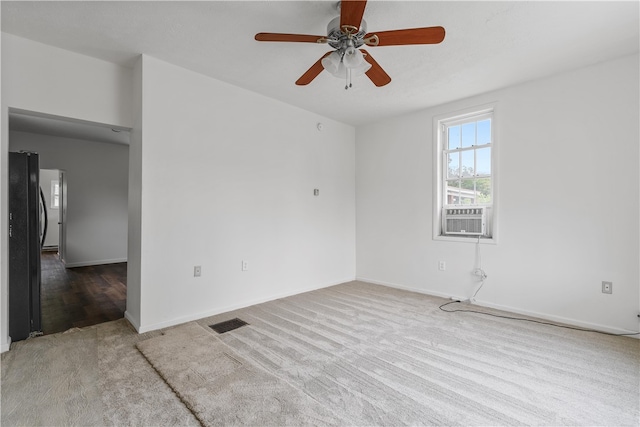 carpeted spare room with ceiling fan and cooling unit