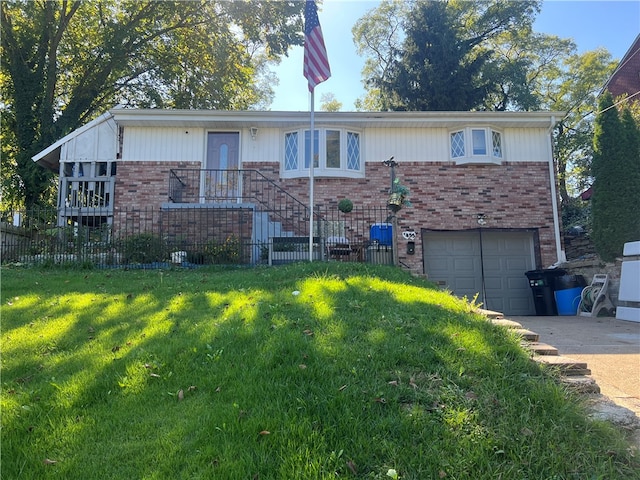 view of front of home with a garage and a front lawn