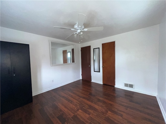 unfurnished bedroom featuring ceiling fan and dark hardwood / wood-style floors