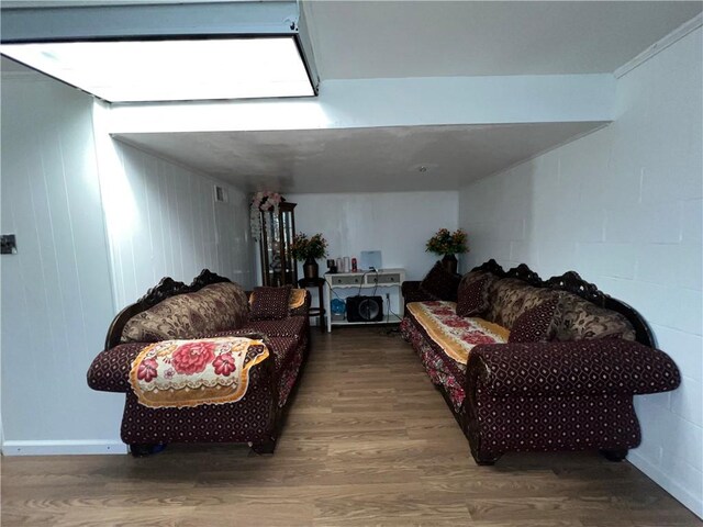 living room with wood-type flooring and ornamental molding