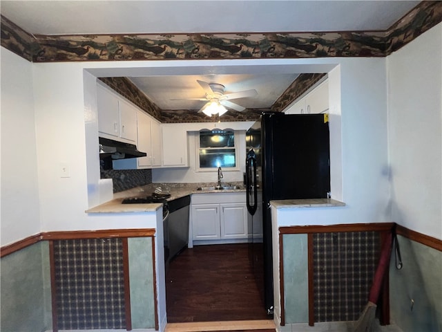 kitchen featuring dark hardwood / wood-style floors, sink, white cabinetry, ceiling fan, and black refrigerator