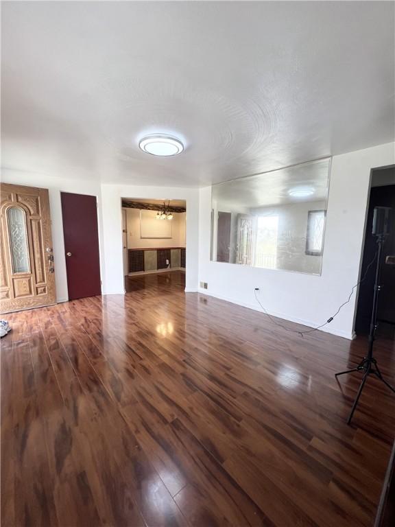 unfurnished living room with wood finished floors
