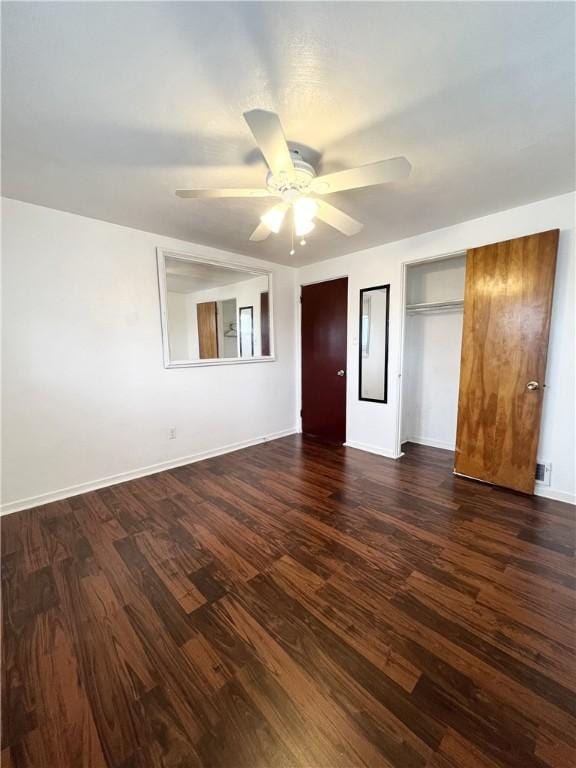 unfurnished bedroom featuring dark wood-type flooring, visible vents, baseboards, and ceiling fan