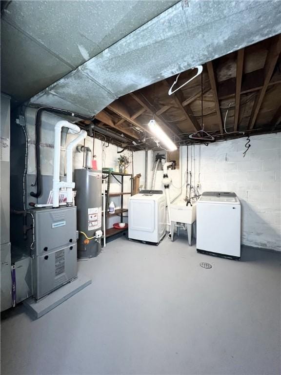 unfinished basement with gas water heater, a sink, concrete block wall, washer and dryer, and heating unit