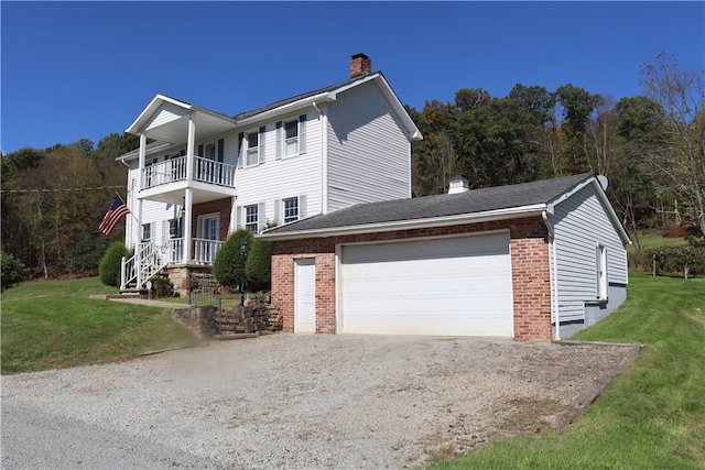 view of home's exterior with a balcony, a garage, and a yard